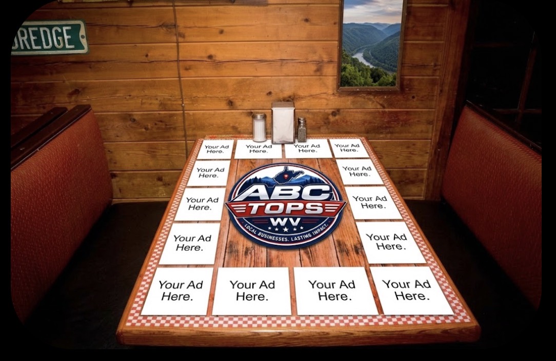 Diner booth table covered edge-to-edge with Your Ad Here ad slots around a centered ABC Tops WV logo